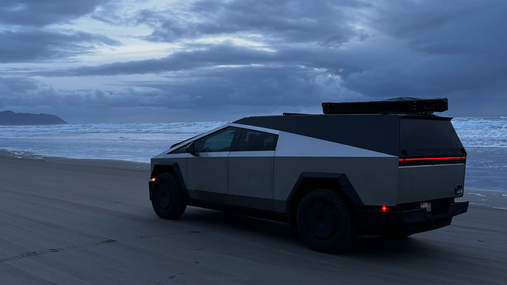 Cybertruck on beach with Space Campers Cap